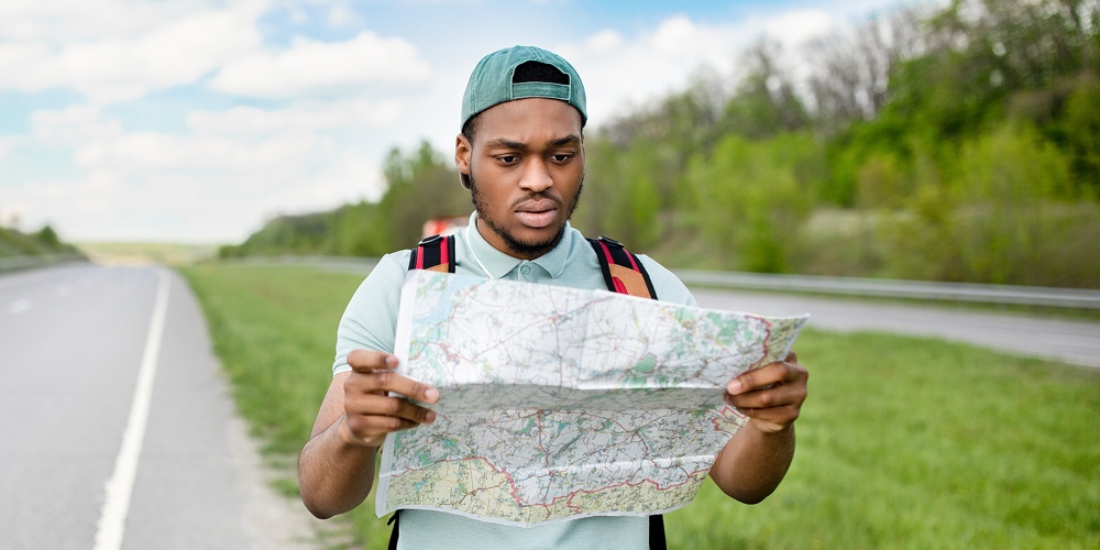 OnTap_home_page|Canvas_home_page|Ent_home_page|Unhappy Young Black Man Hitchhiking On Road