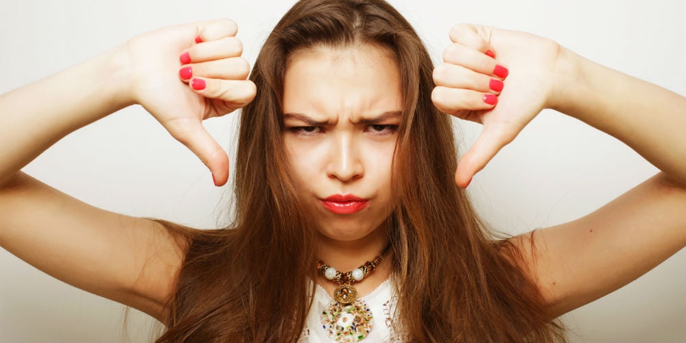 bigstock-Unhappy-woman-giving-thumbs-do-95728529