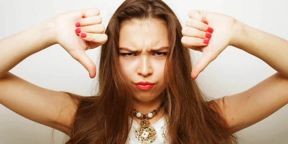 bigstock-Unhappy-woman-giving-thumbs-do-95728529