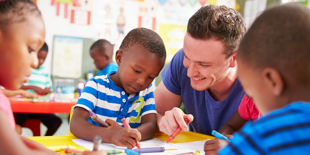 bigstock-volunteer-teacher-helping-a-cl-98584754