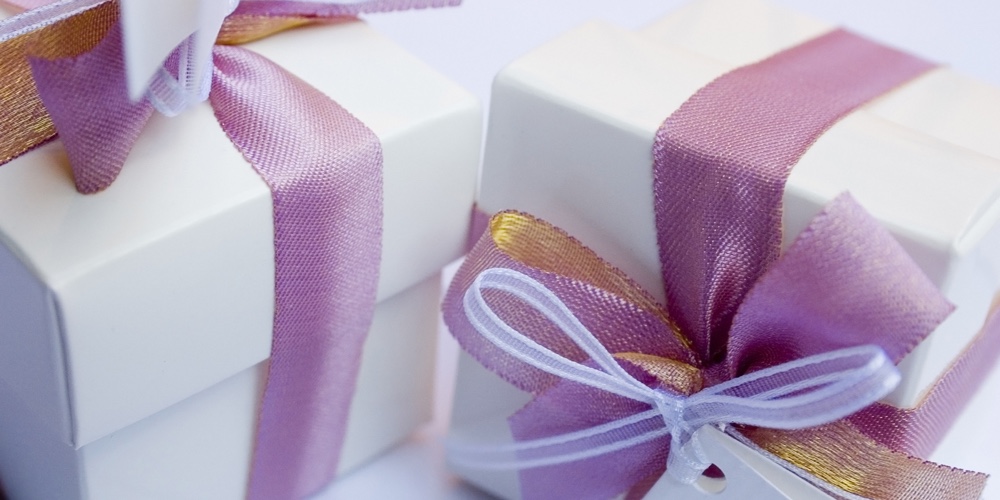 White wedding keepsake close-up with violet ribbon to celebrate a very special day