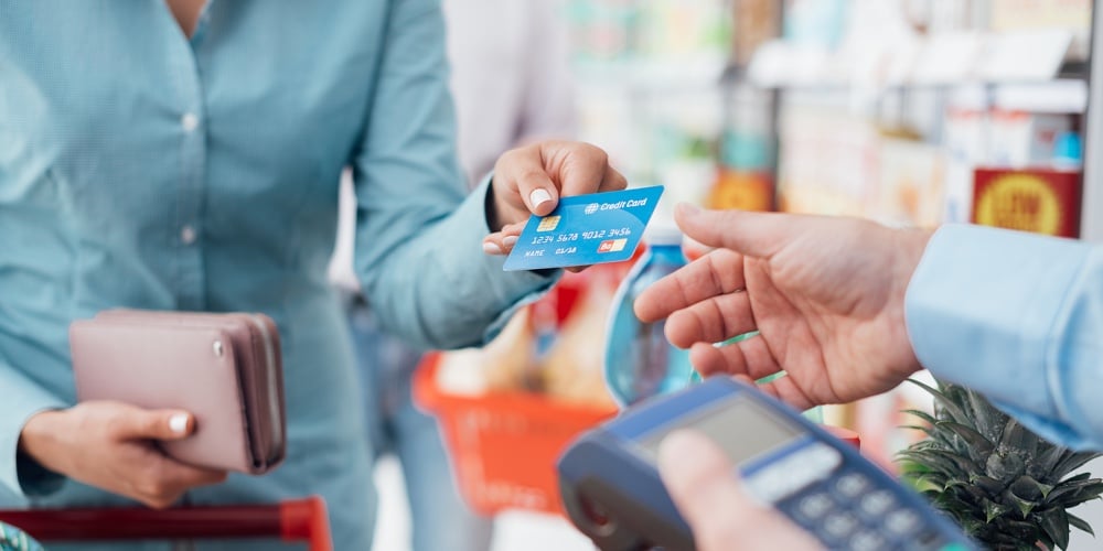 bigstock-Woman-At-The-Store-Checkout-172884626