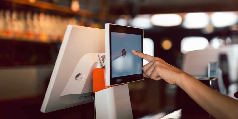 Woman Hand Doing Process Payment On A Touchscreen Cash Register