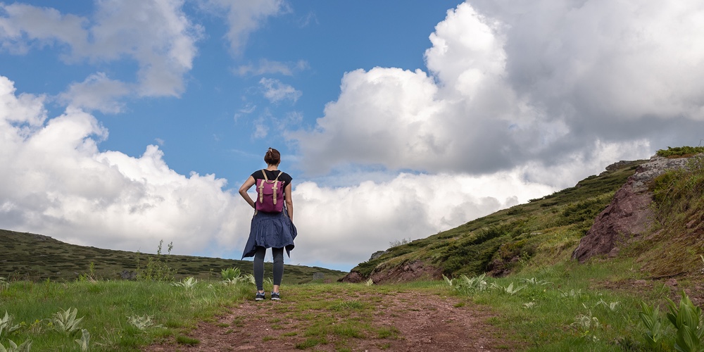 Woman Hiking In Nature In Mountain. Traveling In Nature. Woman Hiking Outdoor Backpacking In Nature.