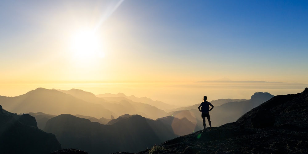 Woman Hiking Silhouette In Mountains