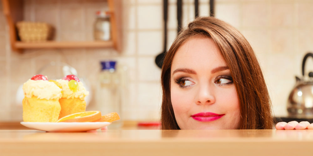 srhdh|bigstock-Woman-Looking-At-Delicious-Swe-98270699