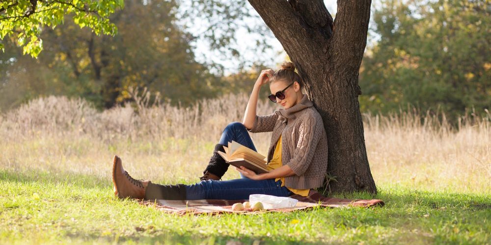 Woman Reading A Book Under The Tree At Daytime
