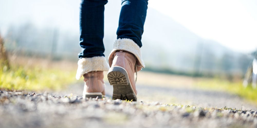 bigstock-Woman-Walking-Along-A-Rural-Pa-75209215