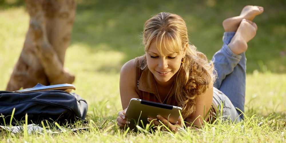 bigstock-Woman-With-Books-And-Ipad-Stud-41219476