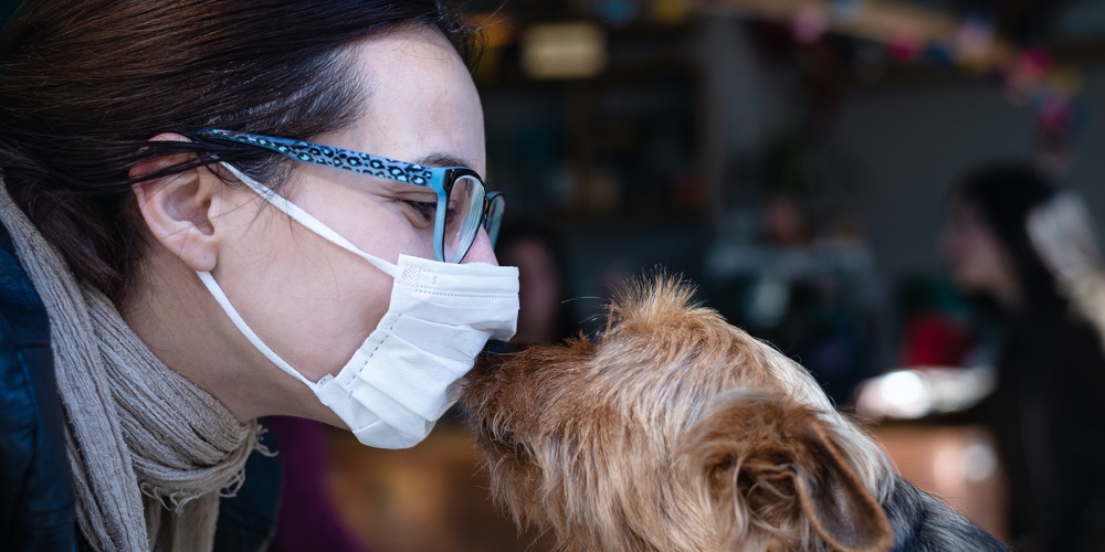 Woman With Mask Kissing Dog. Woman Protecting From Virus. Virus. Living With Coronavirus. Coronaviru