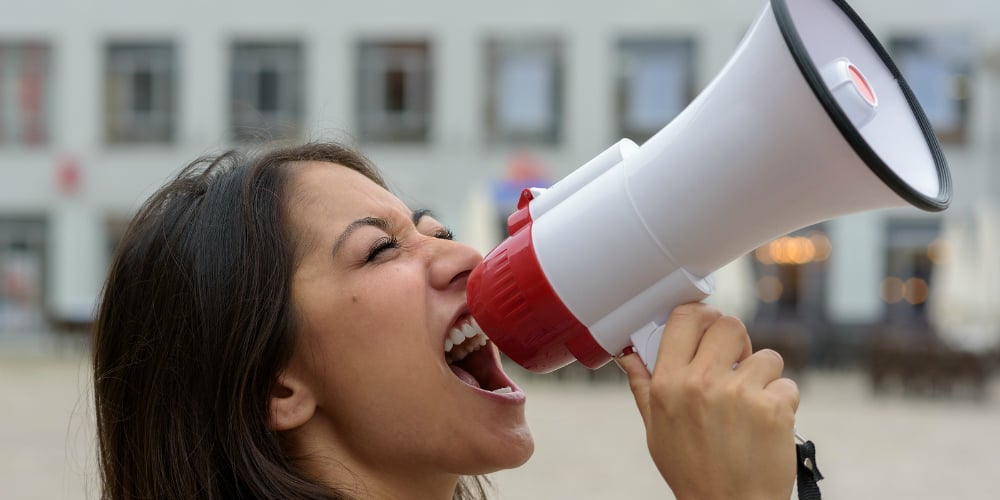bigstock-Woman-Yelling-Into-A-Bullhorn-101438444