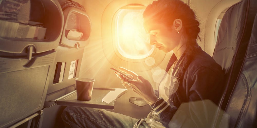 bigstock-Woman-sitting-at-airplane-and-104718377