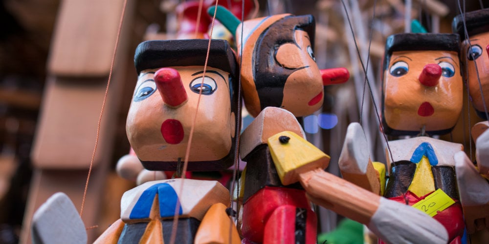 bigstock-Wooden-Pinocchio-Dolls-With-Hi-167471831