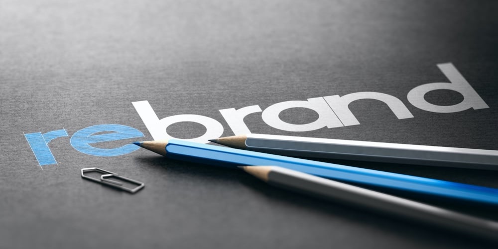 Word Rebrand With The Prefix Re Handwritten Over Black Paper Background