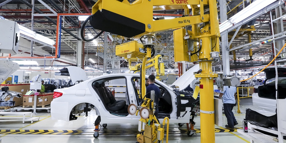 Workers Assembles Cars At Automobile Assembly Line Production Plant