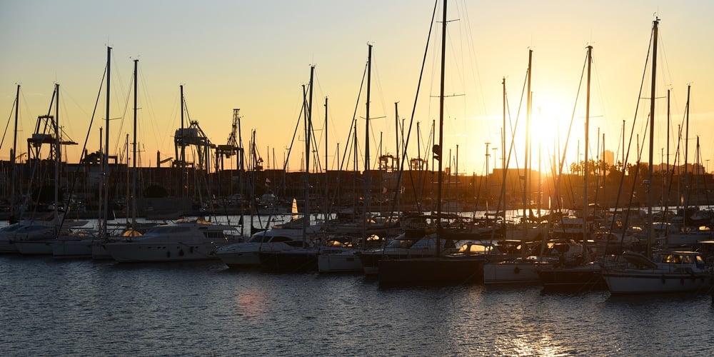 Yachts And Boats In Silhouette Of Sunset In Marina. Sunset At Port. Skiff And Sailboat In Harbour. L