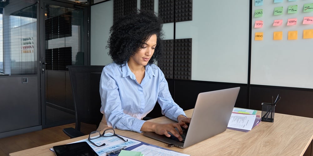 workplace empowerment|Young African American Focused Female Ceo Data Analyst Businesswoman Sitting At Desk Working Typing