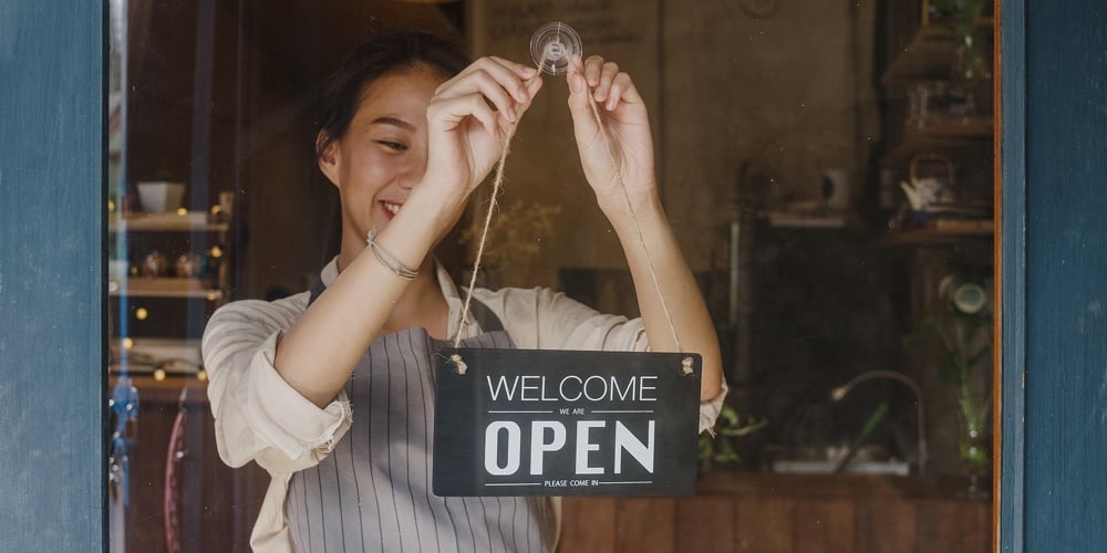 Young Asia Manager Girl Changing A Sign From Closed To Open Sign On Door Cafe Looking Outside Waitin