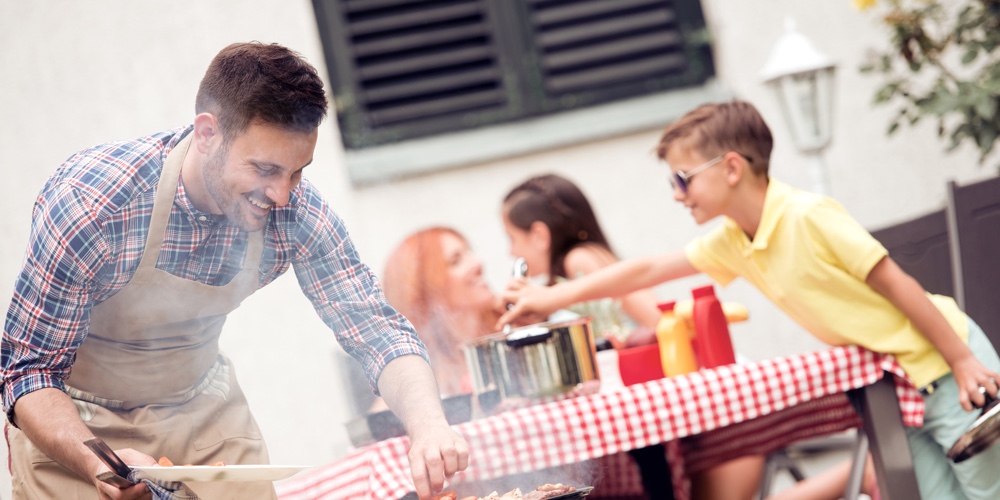 Young Family Make Barbecue At Their Home