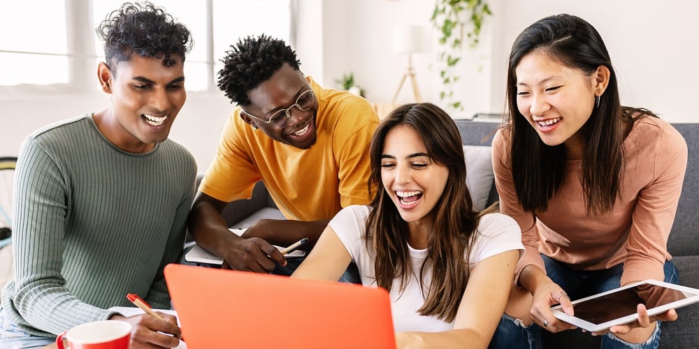 Young Group Of Diverse Students Studying Together Using Laptop At Home – College Multiracial People