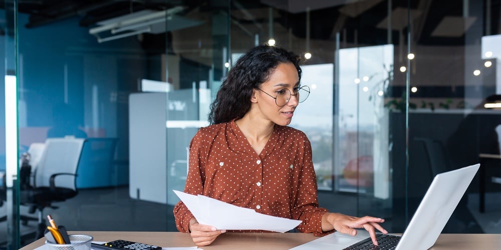 Young Happy And Successful Businesswoman In Glasses Working With Documents Inside Office