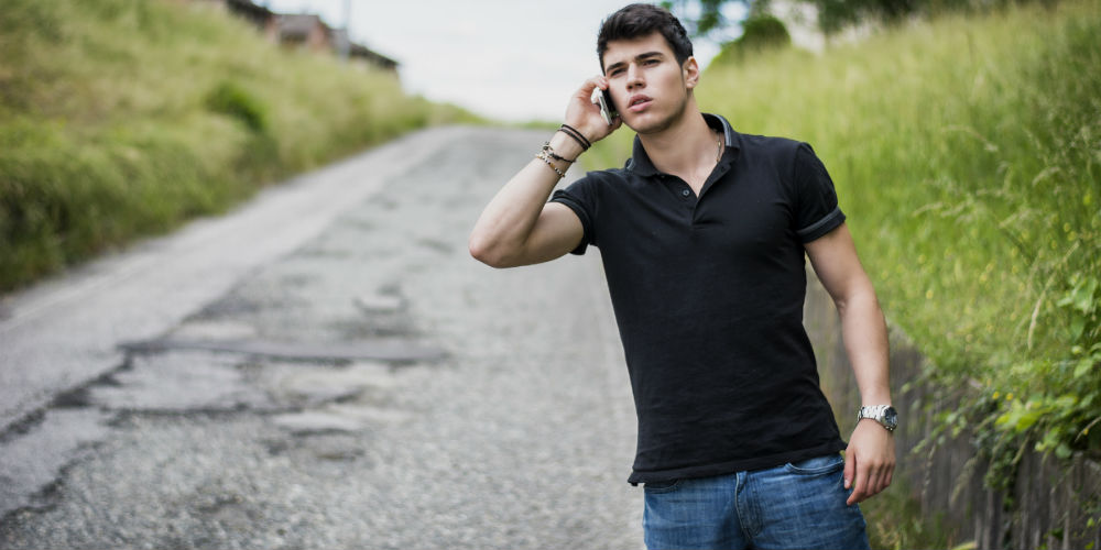 bigstock-Young-Man-On-Side-Of-A-Road-C-91339574
