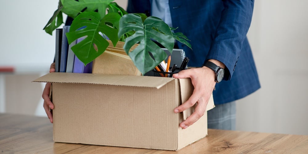 bigstock-Young-Man-With-Box-Of-Belongin-435307838