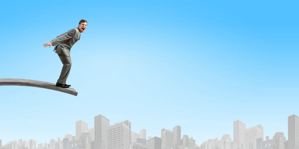bigstock-Young-businessman-jumping-from-82808123