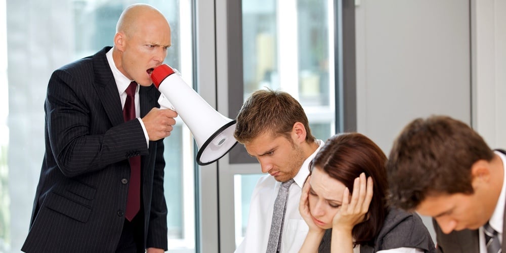 Young confident caucasian businessman screaming on his employee