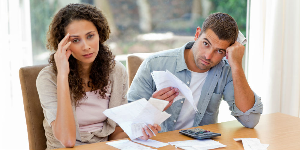 bigstock-Young-couple-calculating-their-13876340