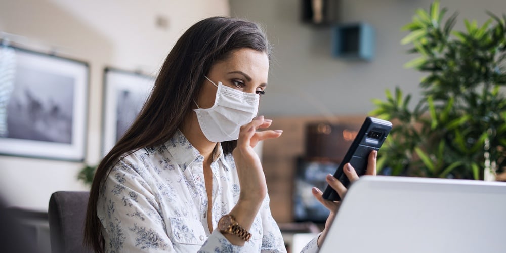 Young woman wering mask. Home office