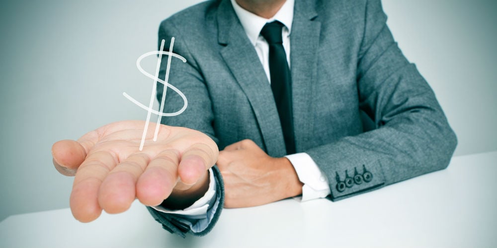 bigstock-a-businessman-sitting-in-a-des-58975436
