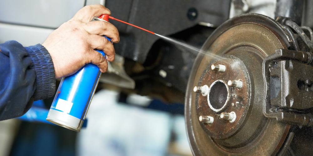 bigstock-car-mechanic-cleaning-car-whee-54244301