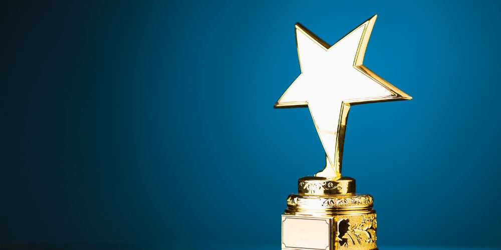bigstock-gold-star-trophy-against-blue-88310900