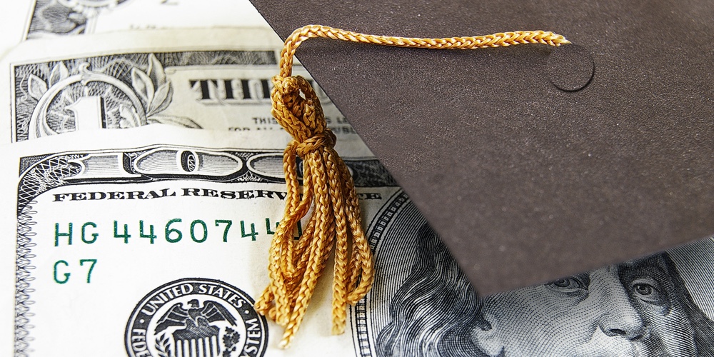 graduation cap on money