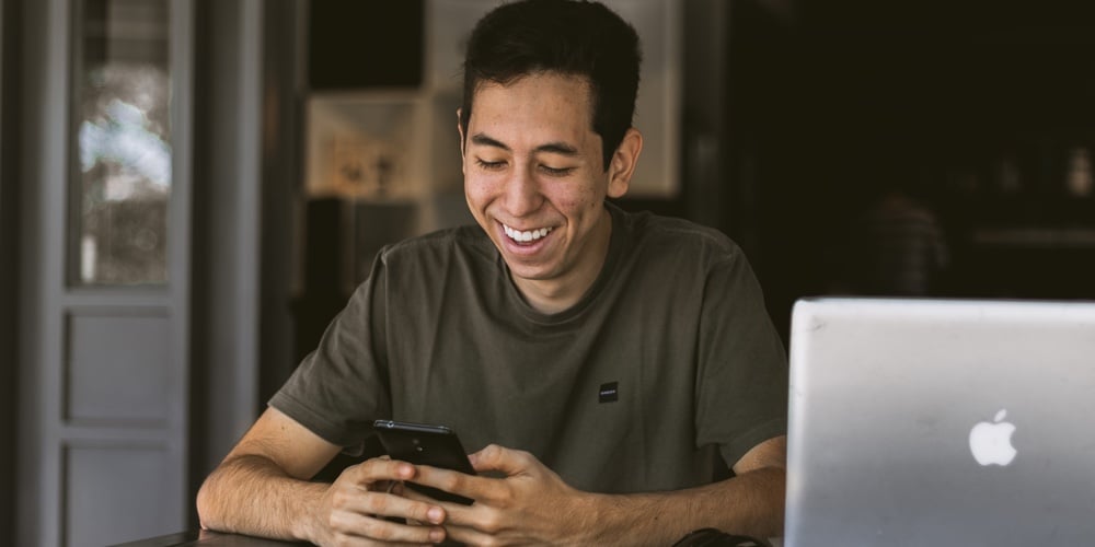 Serious Male User Using Wireless Internet Connection In Public Library. Latin Man Sitting At Desk An