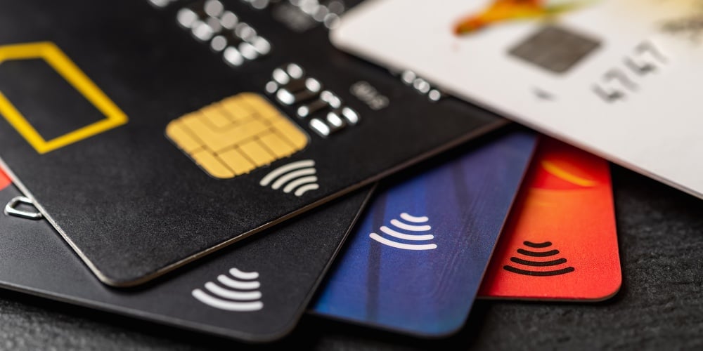 bigstock-Few-Bank-Cards-On-A-Black-Back-442711625