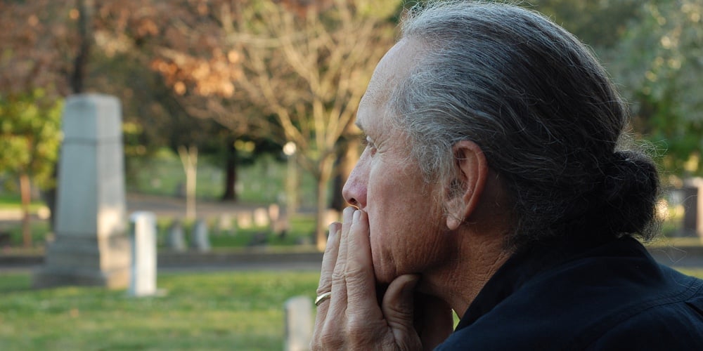 bigstock-Man-Sitting-At-Gravesite-30336203