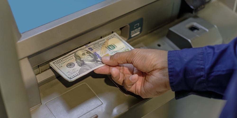 bigstock-A-Man-s-Hand-Extracting-Dollar-477516593