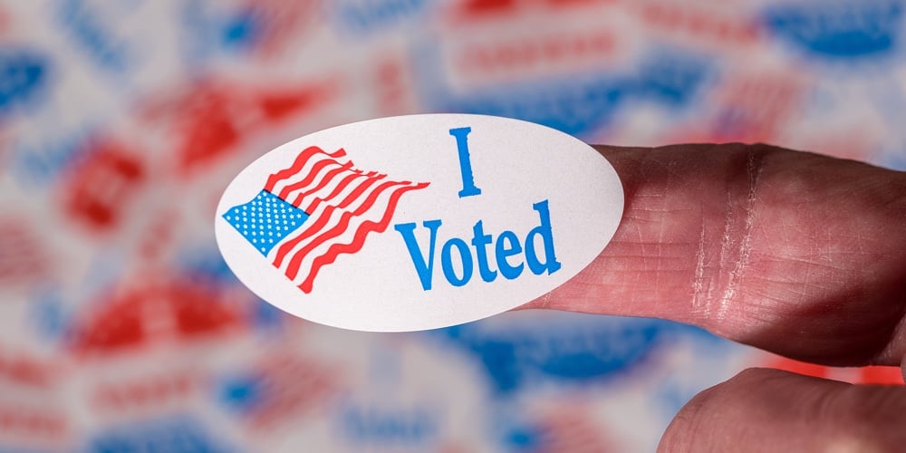 bigstock-Finger-With-I-Voted-Button-In-377231242