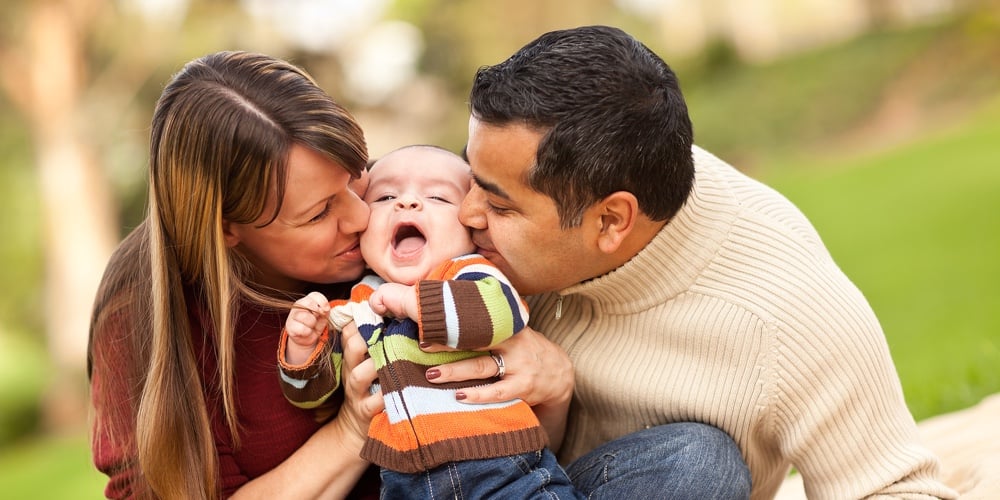 bigstock-Happy-Mixed-Race-Parents-Playi-9992303