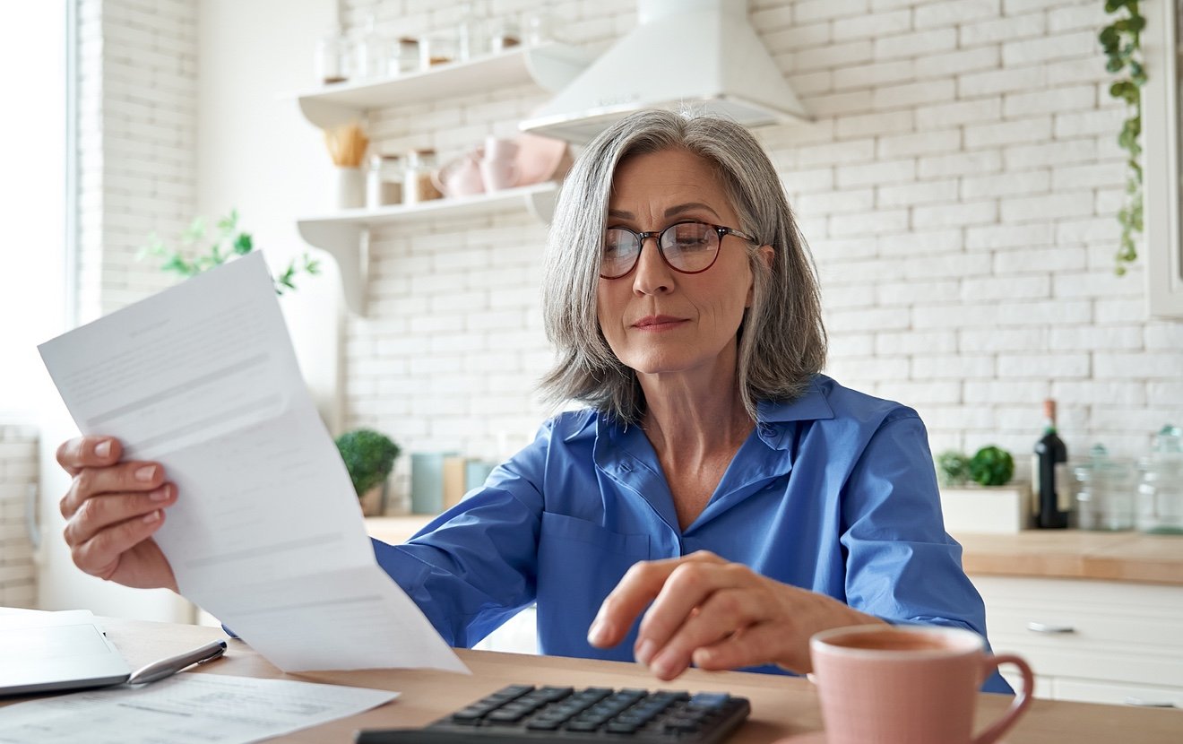 Senior Mature Business Woman Holding Paper Bill Using Calculator, Old Lady Managing Account Finance,
