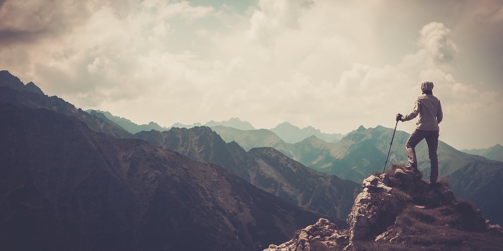 bigstock-Woman-hiker-on-a-top-of-a-moun-73307074