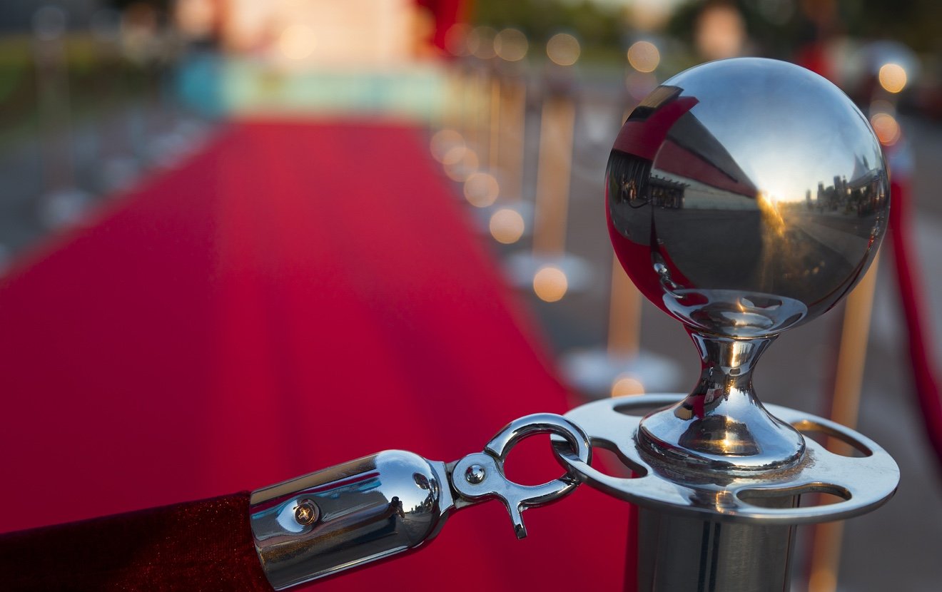 Long red carpet between rope barriers on VIP entrance.