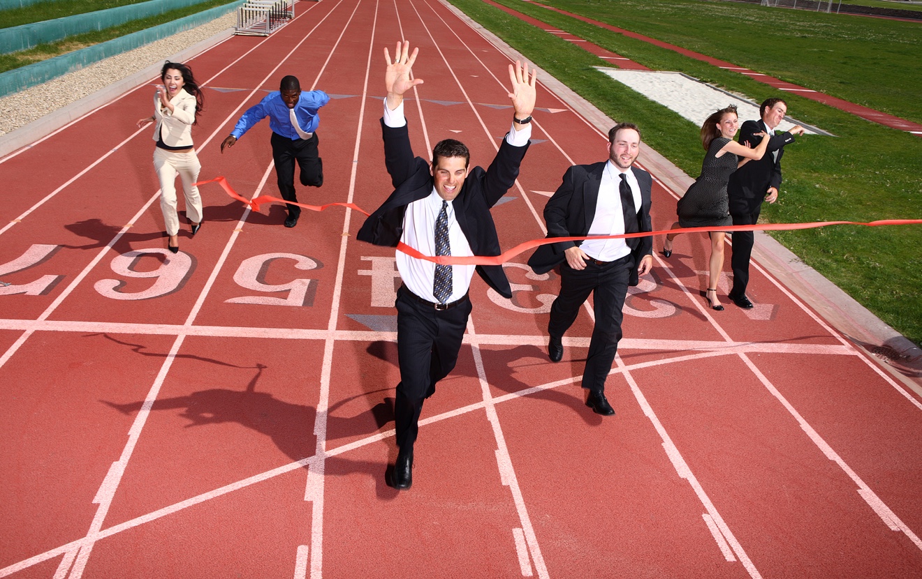 Businesspeople crossing the finish line