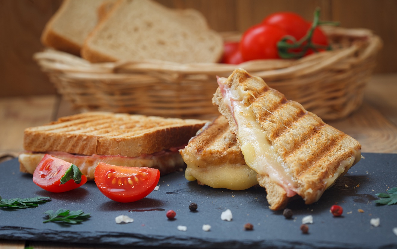 Club Or Toast Sandwiches On Black Tray. Grilled Sandwiches With Ham Salami, Tomato And Melted Cheese