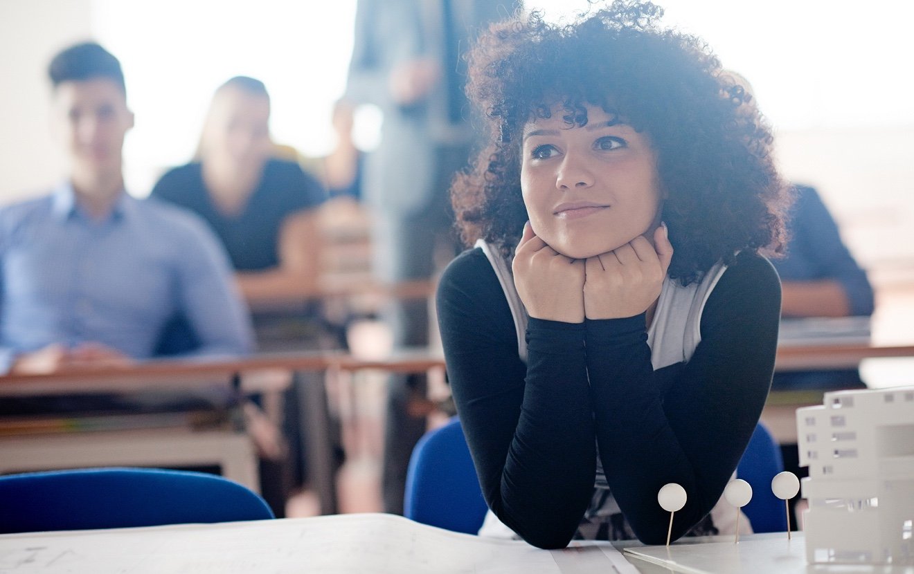 portrait of young female student at school classroom