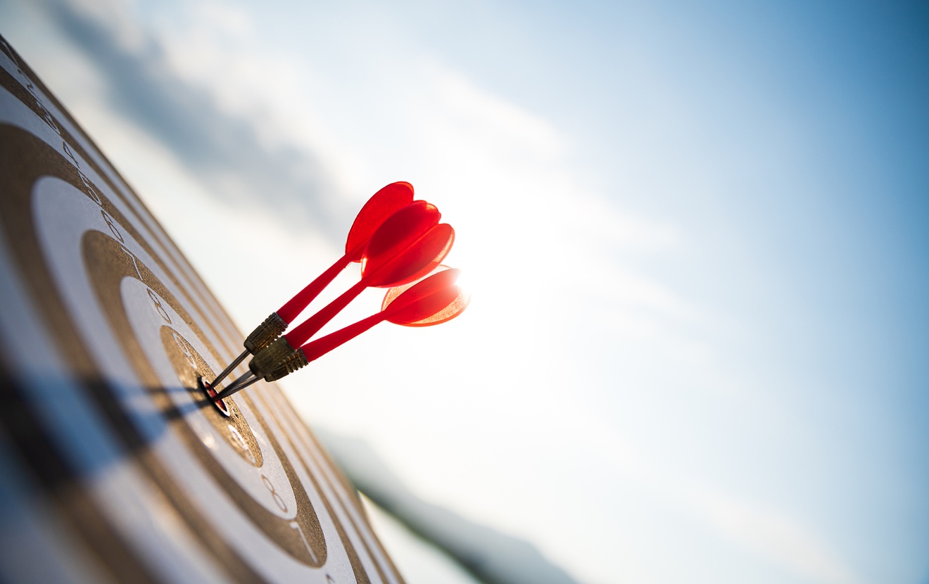 Close Up Shot Red Darts Arrows In The Target Center On Dark Blue Sky Background. Business Target Or