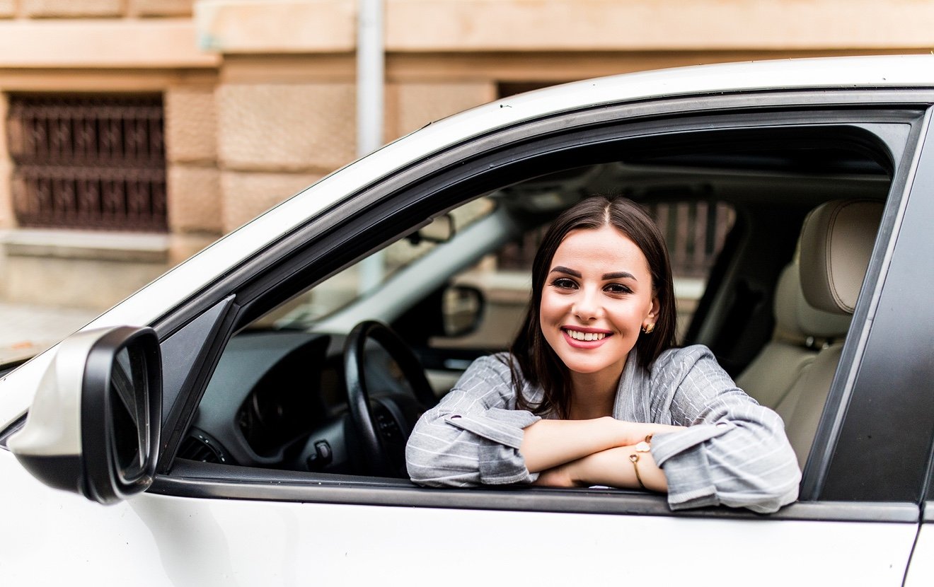 Closeup Portrait Attractive Woman Buyer Sitting In Her New Car Excited Ready For Trip Isolated Outsi