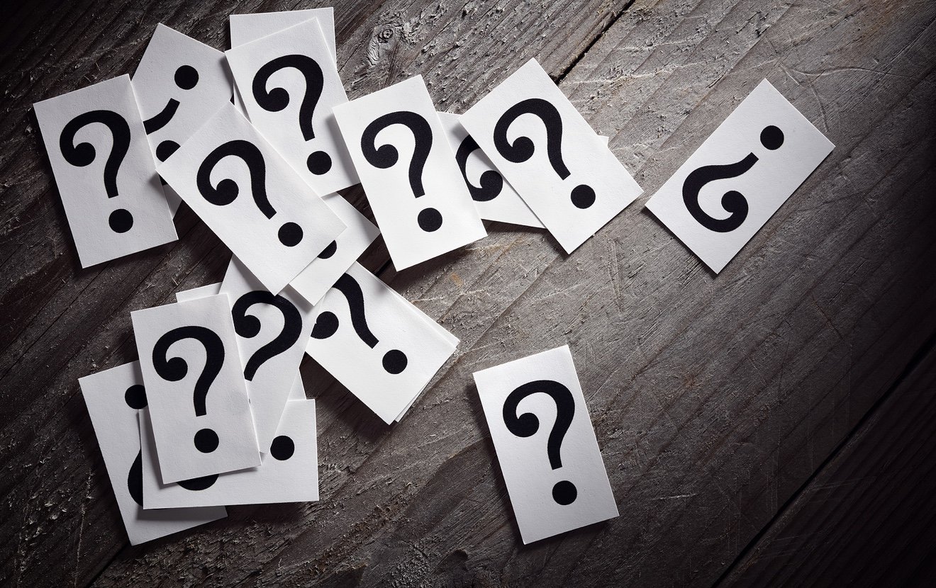 Question mark heap on table concept for confusion, question or solution